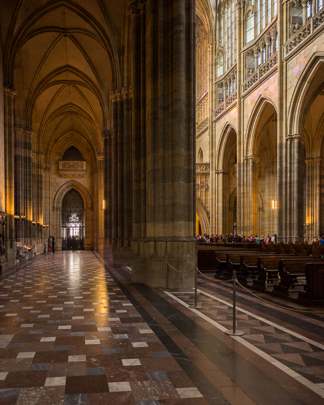 View down the aisles of the cathedral, with the play of afternoon light through the windows.