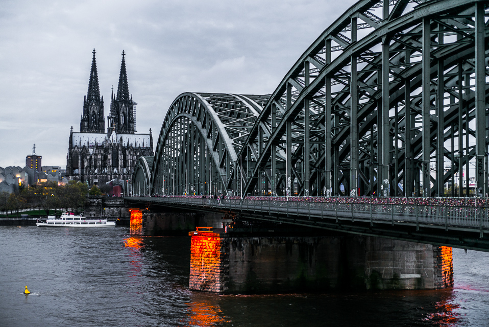 The railway bridge crossing the Rhine with the Cathedral. The bridge is adorned with a multitude of "Lover's Locks".